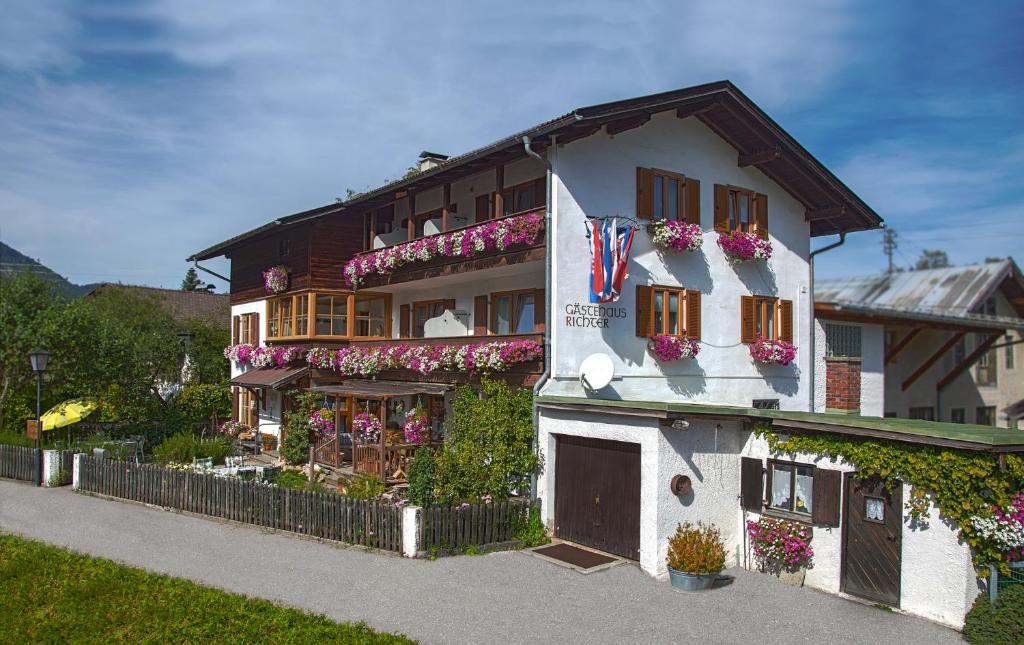 a building with flower boxes on the side of it at Gaestehaus Richter in Oberammergau