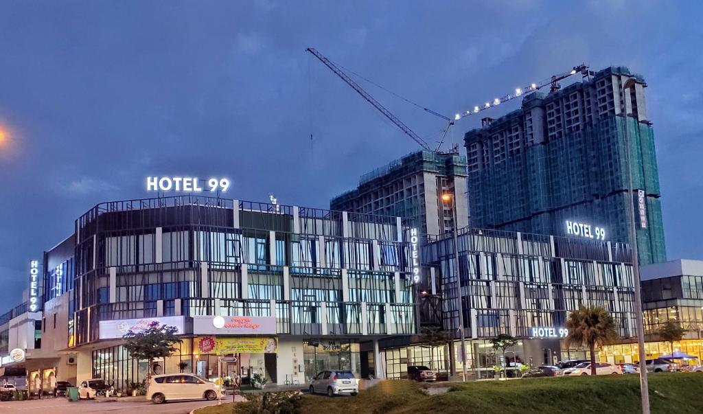 a building with a crane on top of it at Hotel 99 Sepang KLIA & KLIA2 in Sepang