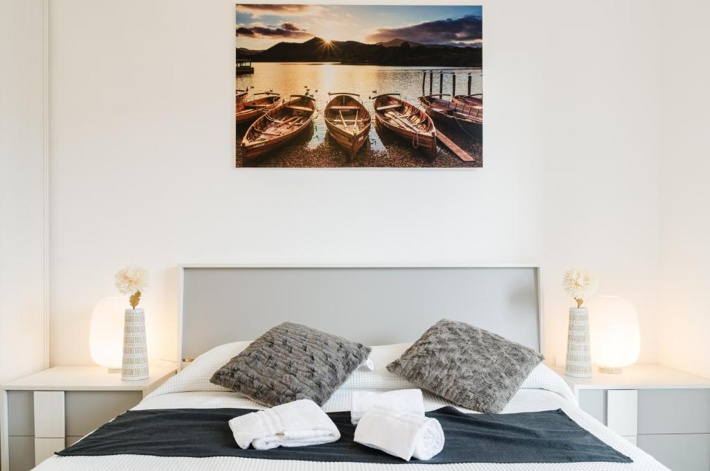 a bedroom with a bed with three boats on the water at Fco Secrets Luxury Apartment in Fiumicino