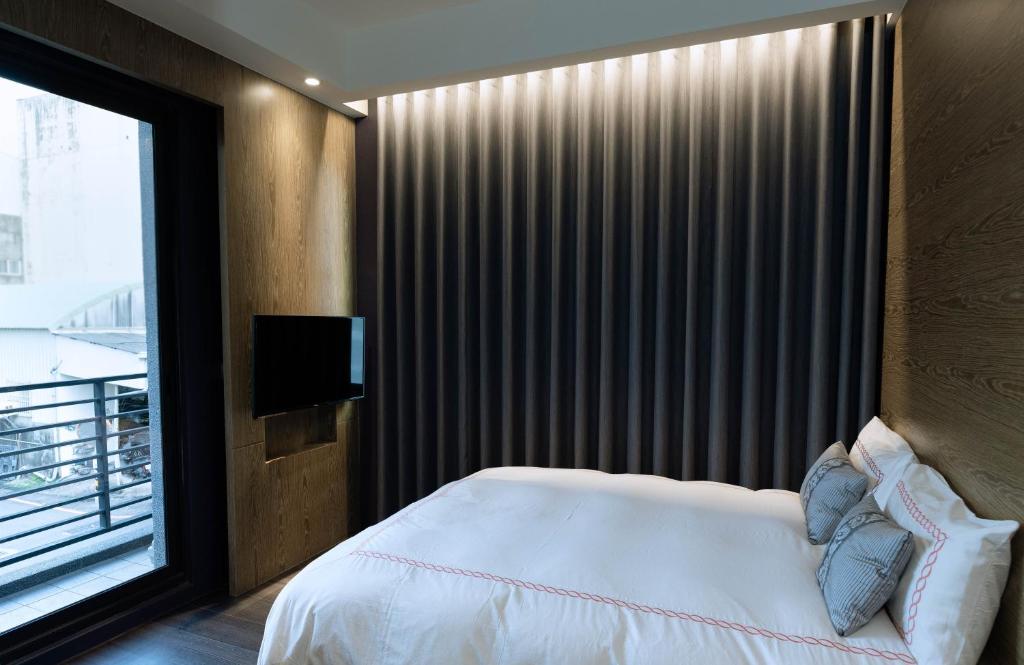 Postel nebo postele na pokoji v ubytování Tianli Hotel