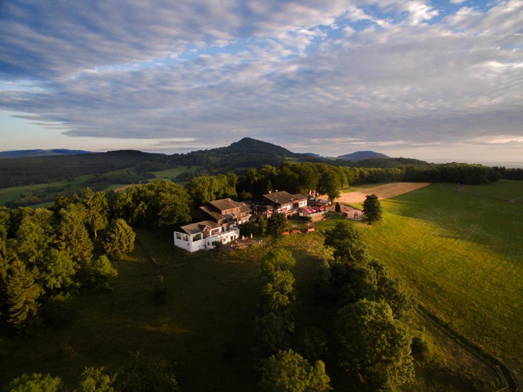 an aerial view of a house in the middle of a field at Berghotel Lothar-Mai-Haus in Hofbieber