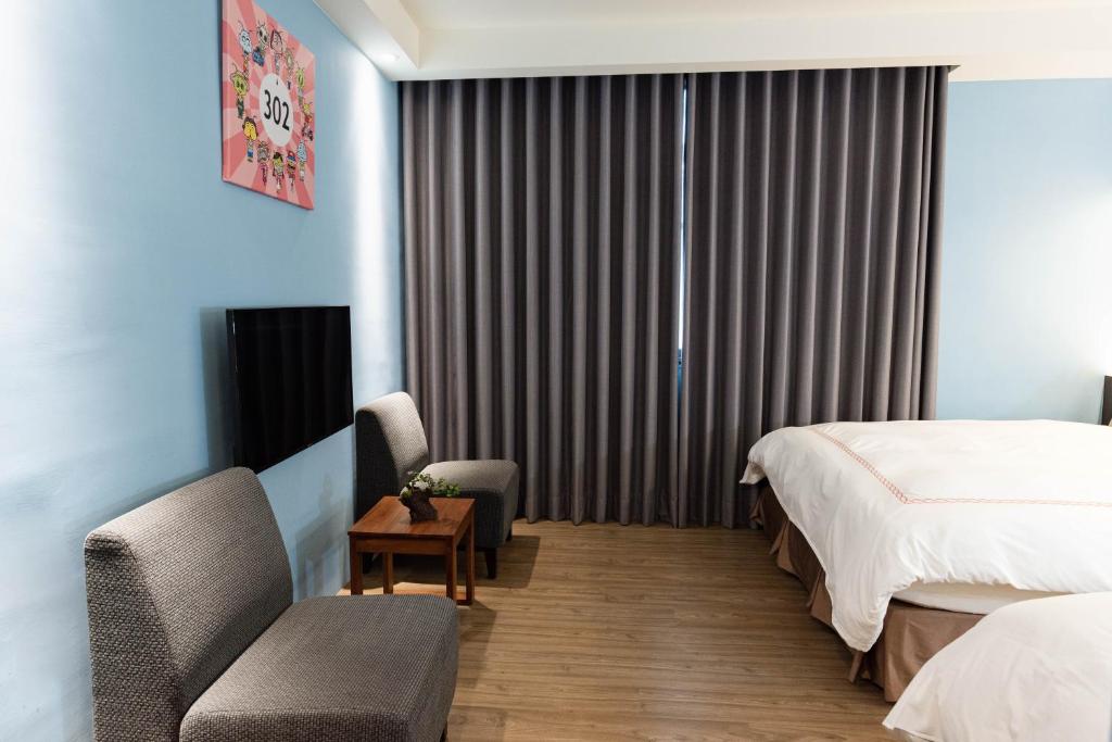 Postel nebo postele na pokoji v ubytování Tianli Hotel
