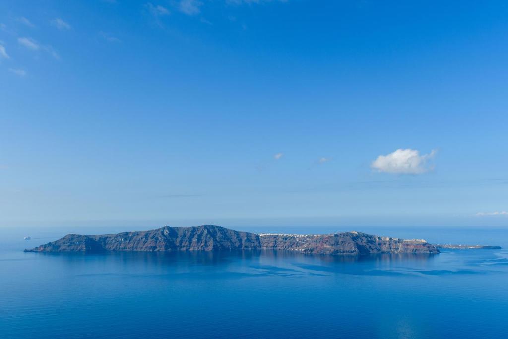 an island in the middle of a large body of water at Above Blue Suites in Imerovigli