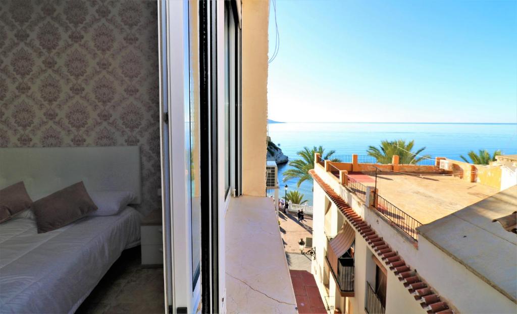 a balcony with a bed and a view of the ocean at Sant Lorenzo Suite in Benidorm