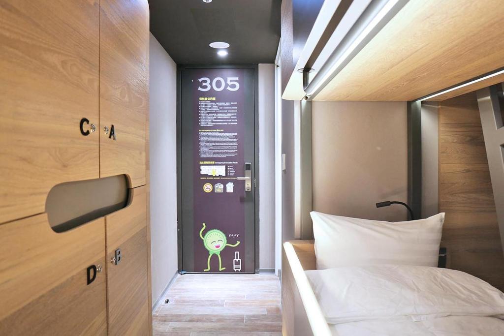 Rúm í herbergi á KIWI SHARE HOTEL ZHONGLI