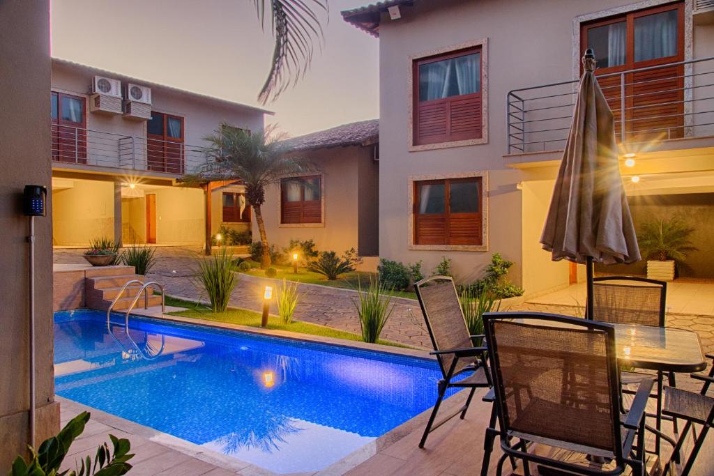 a swimming pool in the backyard of a house at Hotel Vila Serrana in Sete Lagoas