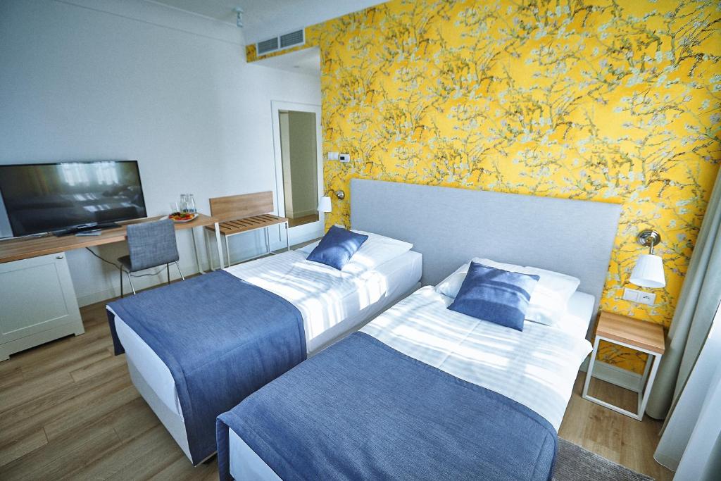 Posteľ alebo postele v izbe v ubytovaní Hotel Afrodyta Business & Spa