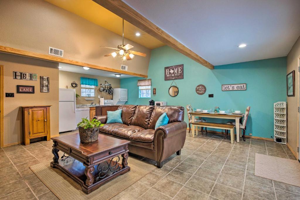 a living room with a couch and a table at Lake Texoma Cabin - 1 Mi to Park and Boat Ramp! in Willow Spring