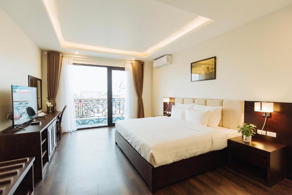 Postel nebo postele na pokoji v ubytování Paragon Noi bai Hotel & Pool