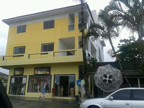 a yellow building with a soccer ball in front of it at Pousada Encantadas in Pontal do Paraná