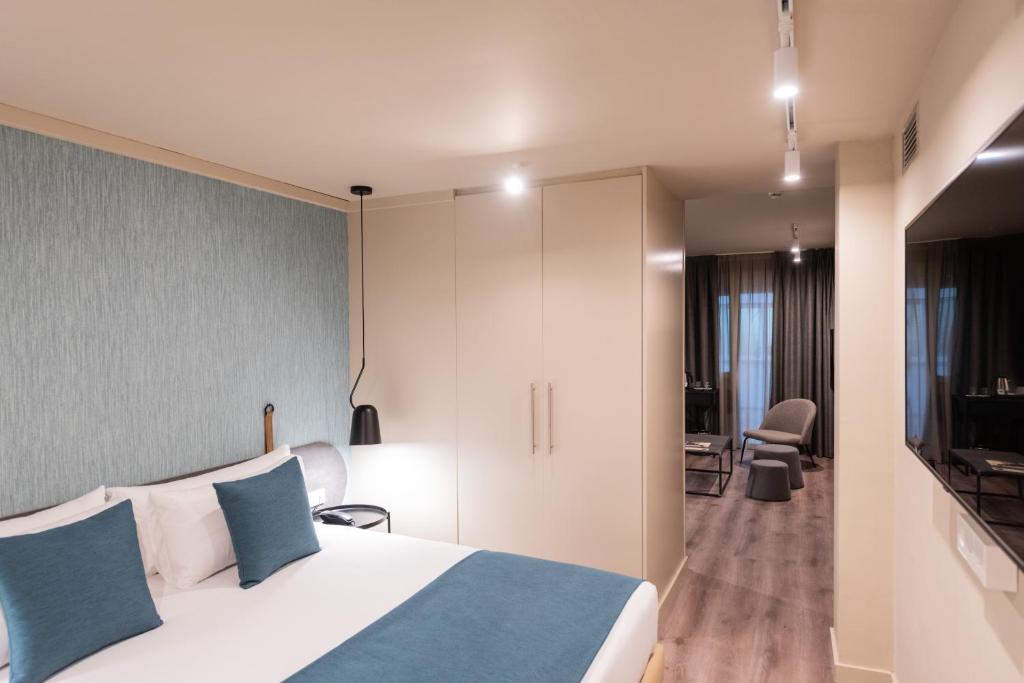 Posteľ alebo postele v izbe v ubytovaní Atenea Rekord Suites
