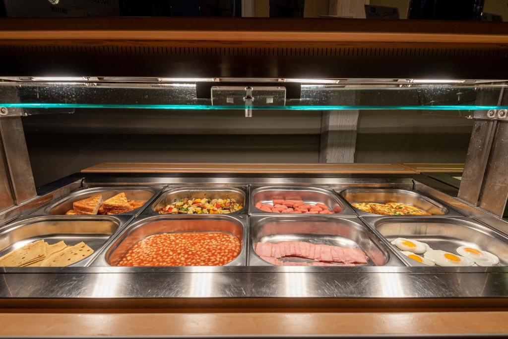 an oven with many trays of food in it at Kordistos Hotel in Kefalos