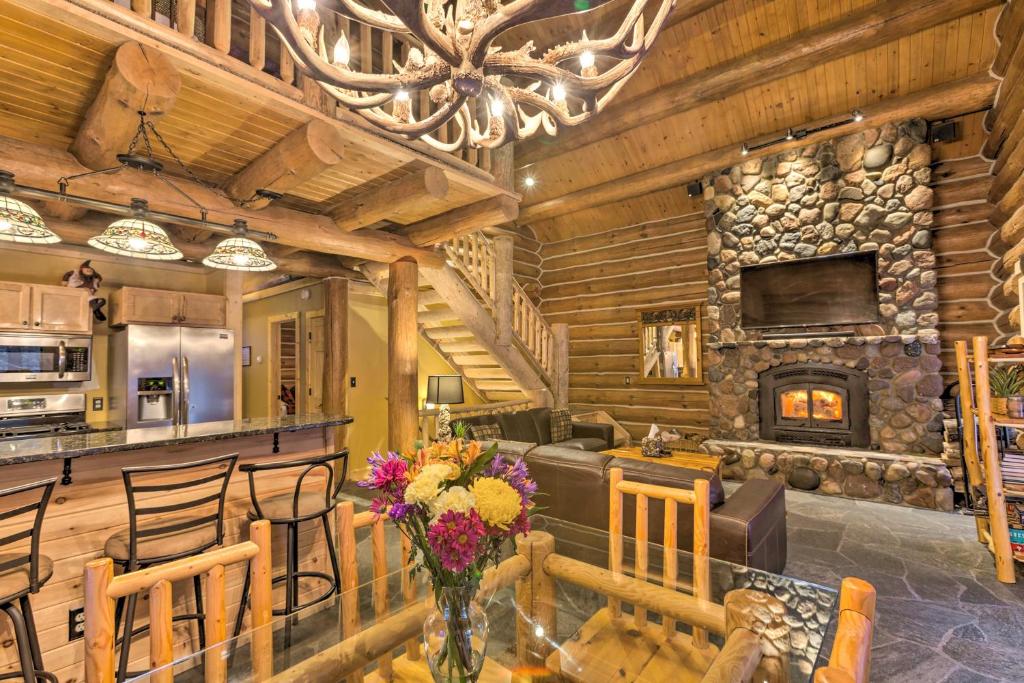 a dining room and living room with a stone fireplace at Secluded Traverse City Retreat - Near Downtown! in Traverse City