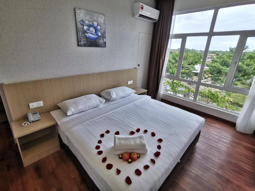 Postel nebo postele na pokoji v ubytování Green World Hotel