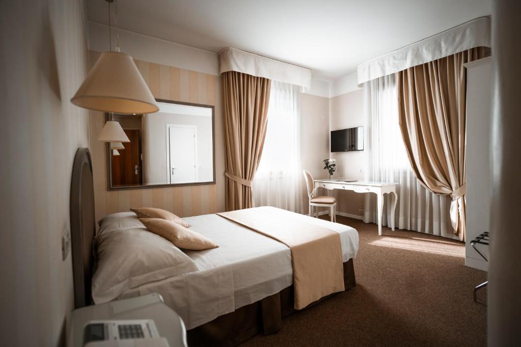 Postel nebo postele na pokoji v ubytování Bonotto Hotel Belvedere