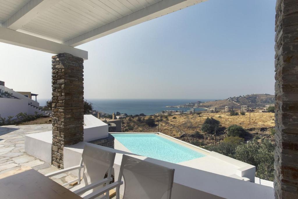 a view of a swimming pool from a villa at modern apartment with a sea view and swimming pool in Koundouros in Koundouros