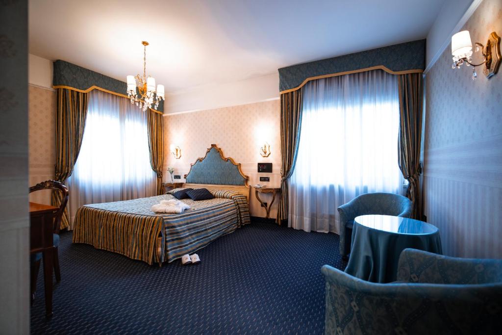 Postel nebo postele na pokoji v ubytování Bonotto Hotel Belvedere