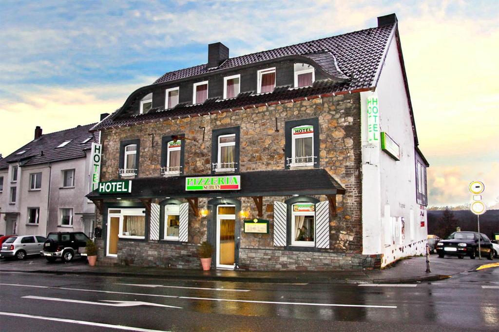 a building on the corner of a street at Hotel Schwan in Eschweiler