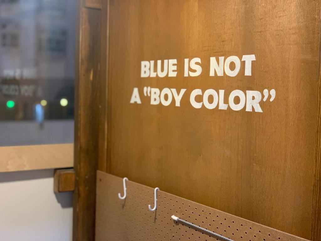 a door with a sign that says blue is not a box color at Wontonmeen in Hong Kong