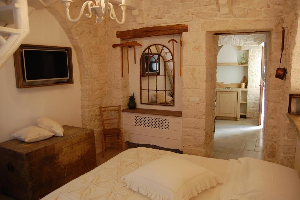 Postel nebo postele na pokoji v ubytování Trulli Holiday Albergo Diffuso