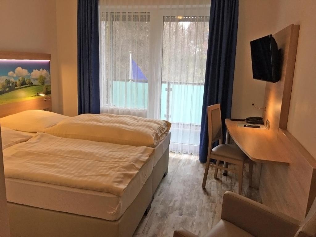 Postel nebo postele na pokoji v ubytování Hotel Hesborner Kuckuck