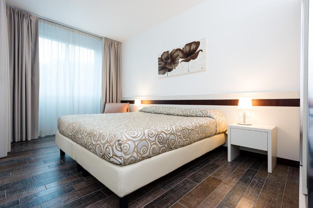 Postel nebo postele na pokoji v ubytování Aparthotel Holiday