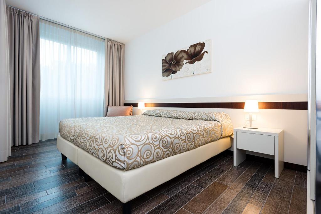 Кровать или кровати в номере Aparthotel Holiday