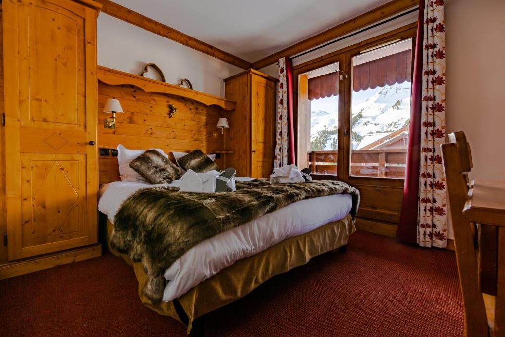 Łóżko lub łóżka w pokoju w obiekcie Appartement 5* Prince des Cimes
