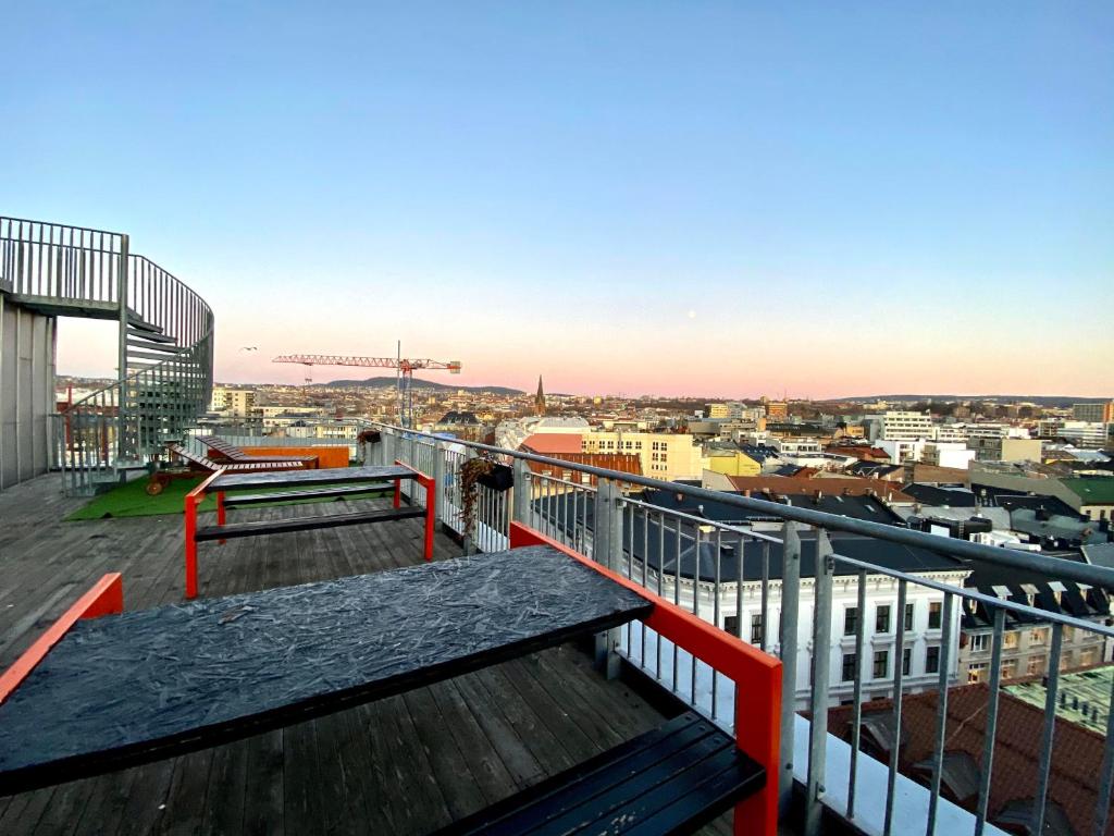a balcony with a table and a view of a city at Comfort Hotel Xpress Youngstorget in Oslo
