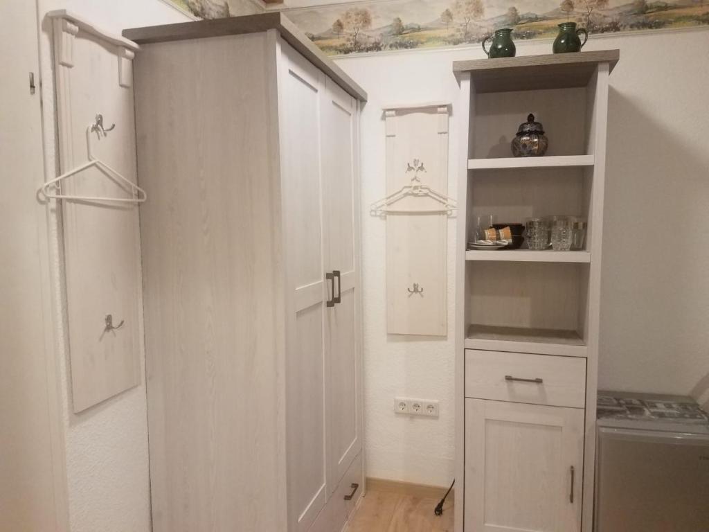 a white kitchen with white cabinets and a stove at Ferienwohnung Wacker, Apartments und Zimmer in Züschen