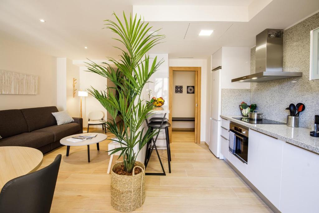 a kitchen and living room with a couch and a table at Suites Castellón in Castellón de la Plana