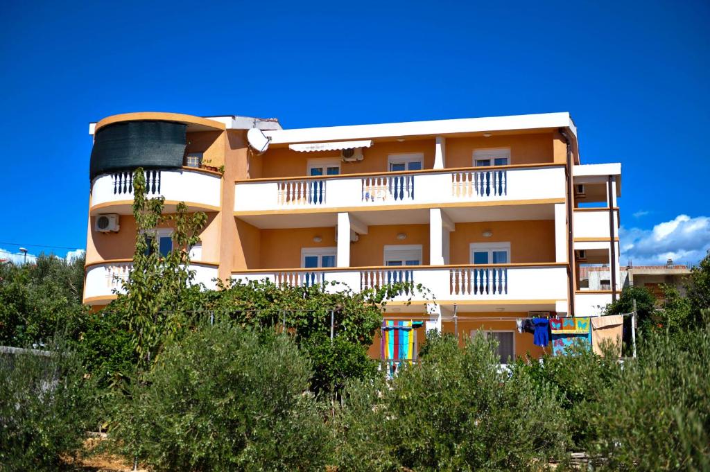 a building with balconies on the side of it at Dorica Dabo in Novalja