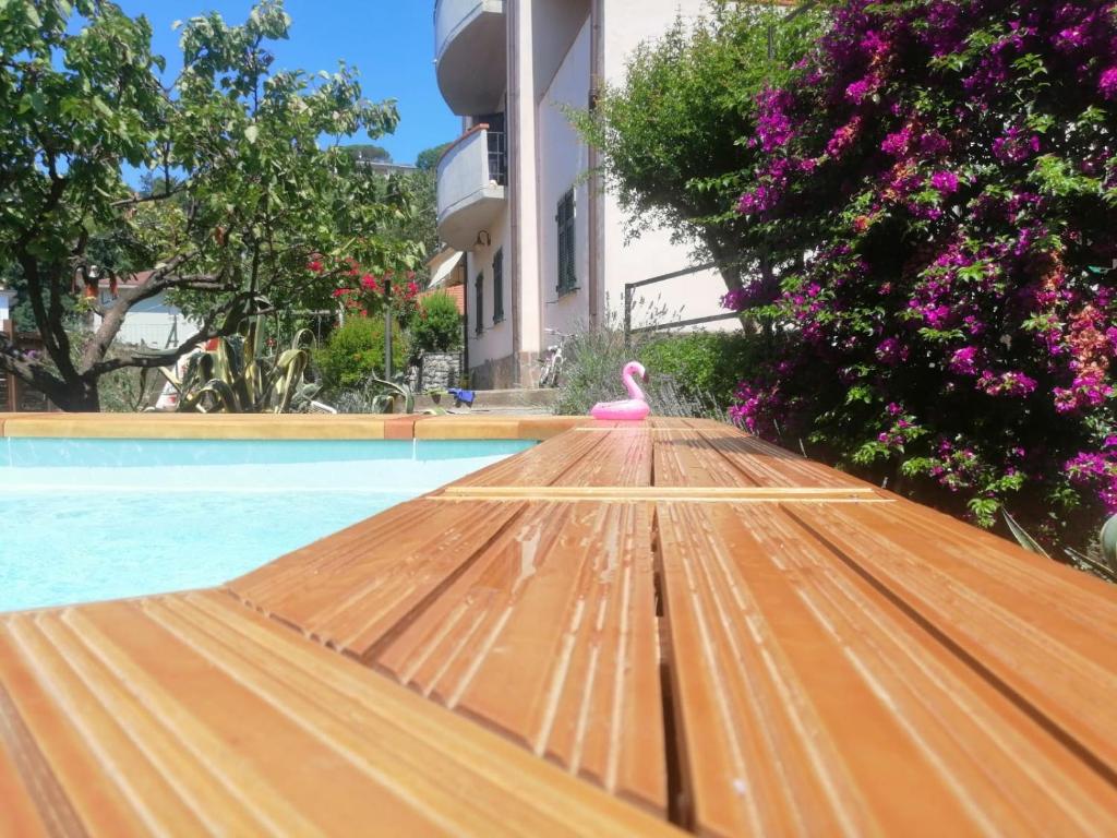 a swimming pool with a pink flamingo on a wooden deck at Lucky House in La Spezia