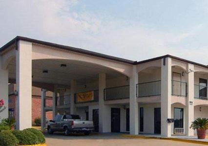 a building with a truck parked in front of it at Key West Inn - Montgomery South in Montgomery