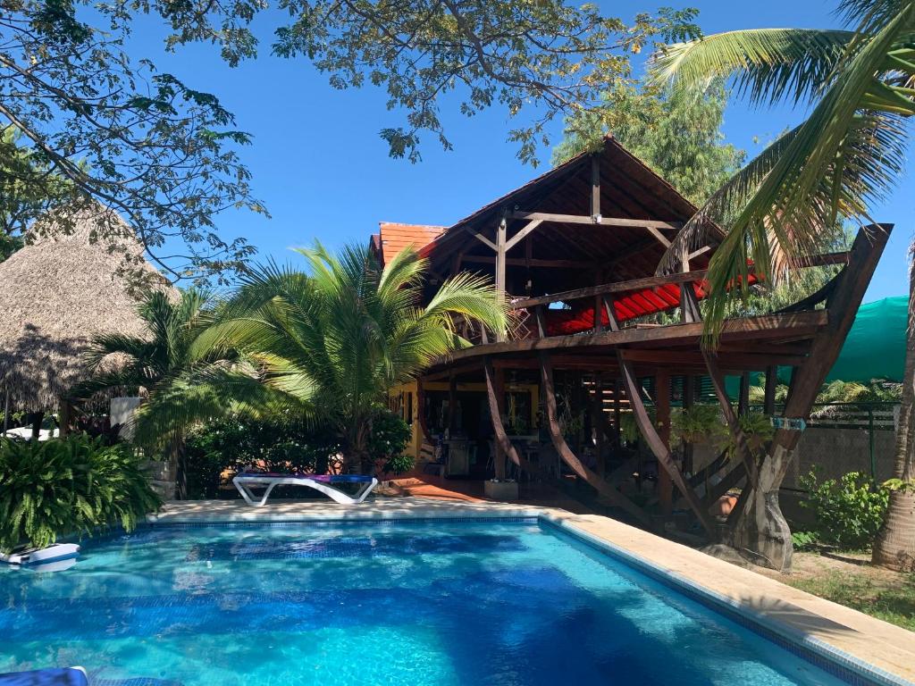 a resort with a swimming pool and a house at El Arca de Pachue in Punta Chame