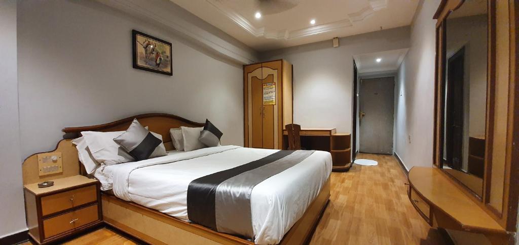 Postel nebo postele na pokoji v ubytování Hotel JMC Group
