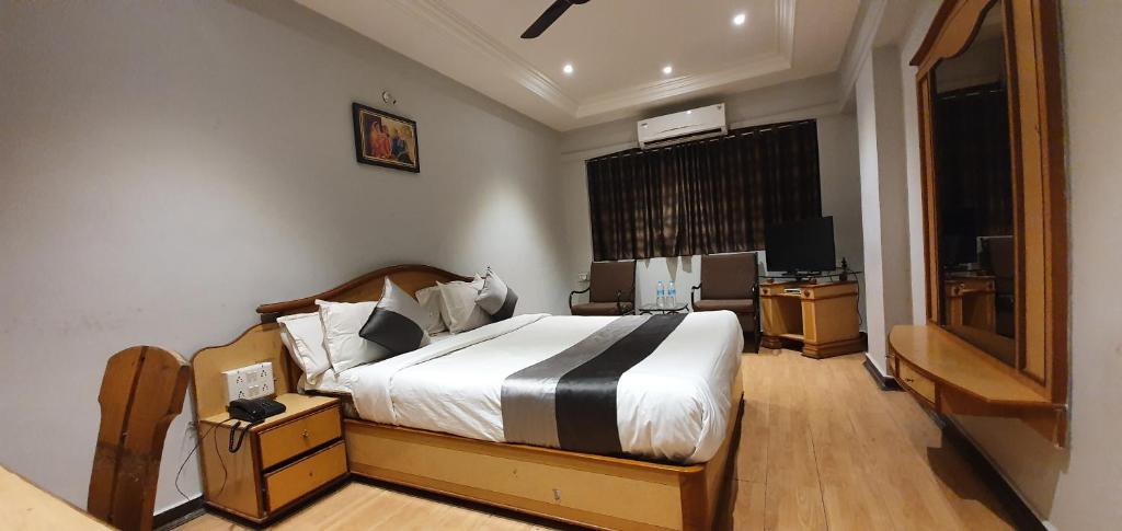 Postel nebo postele na pokoji v ubytování Hotel JMC Group