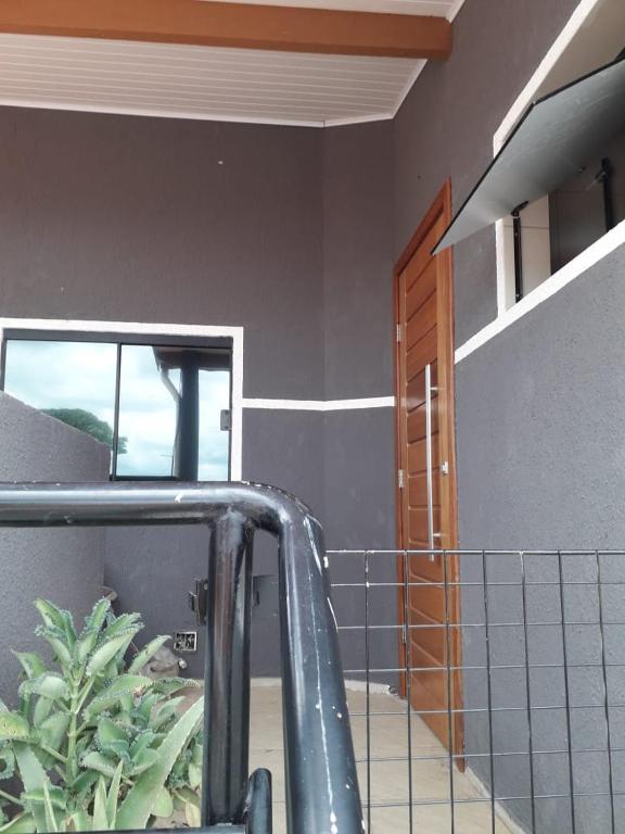 a room with a staircase and a window and a door at Casa do Henrique 1 in Sorocaba