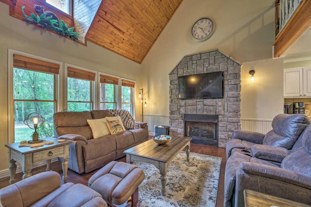 a living room with a couch and a fireplace at Updated Cabin on White River by Boat Landing! in Calico Rock