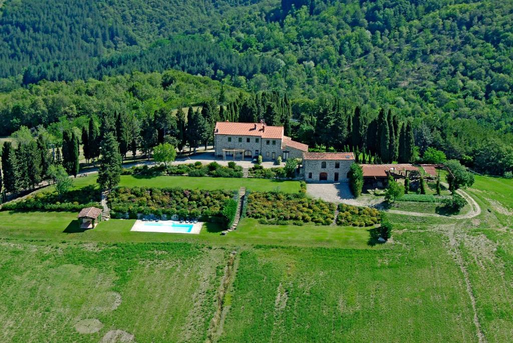 an aerial view of a large house in a field at Villa Poggio dei Cipressi in Subbiano