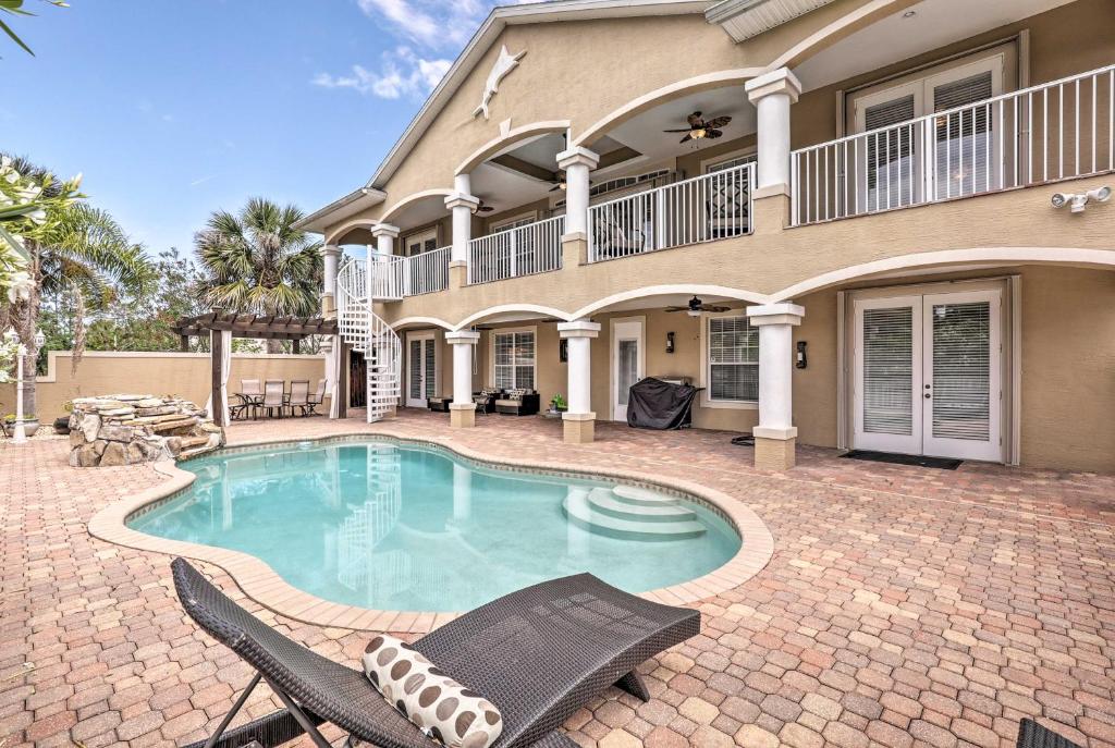 a house with a swimming pool in front of a house at Luxury Palm Coast Home with Dock and Game Room! in Palm Coast