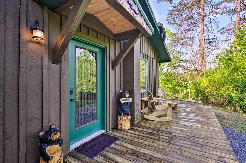 a front porch of a house with a blue door at Secluded Cabin with Hot Tub, 3 Mi to Pigeon Forge! in Sevierville