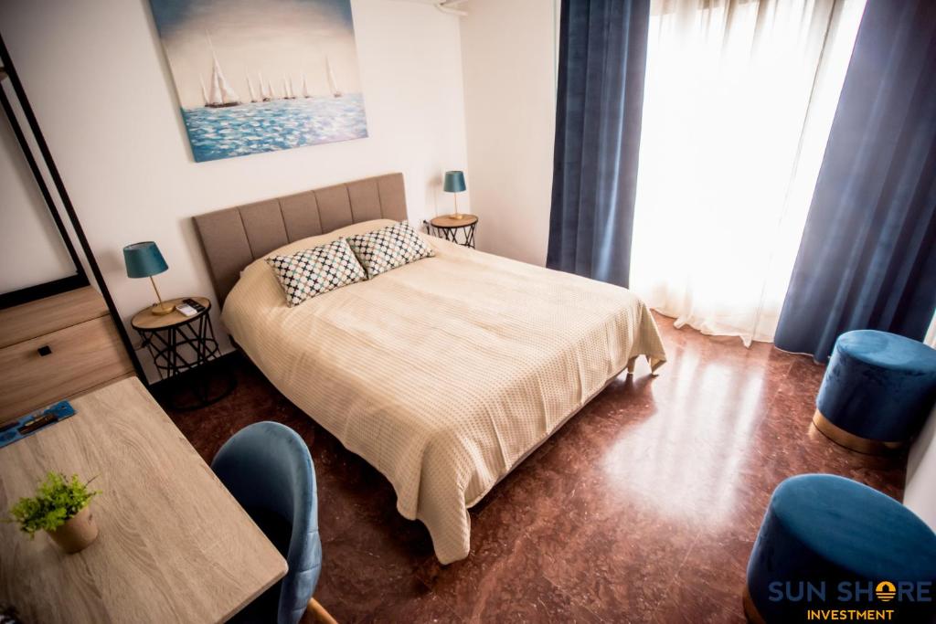 a bedroom with a bed and a table and chairs at Explore Greece from Lovely City Centre Apartment in Chalkida