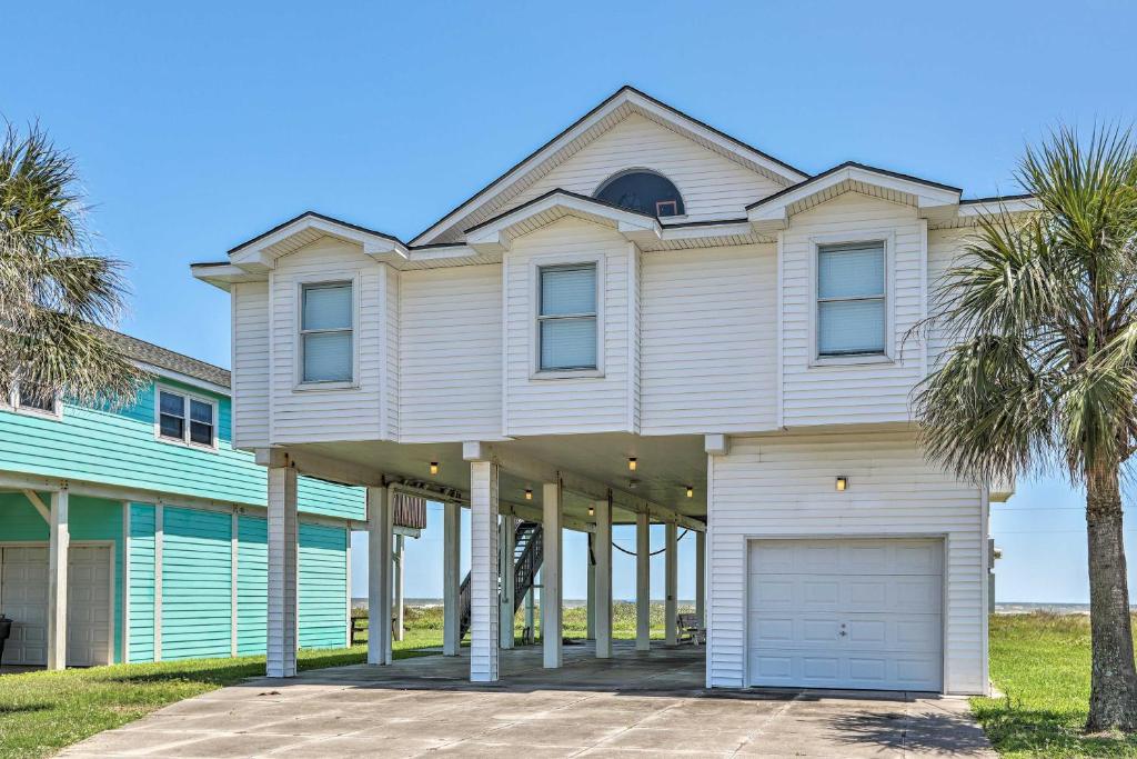 a large white house with a garage at Oceanfront Galveston Home - Walk to Beach! in Galveston