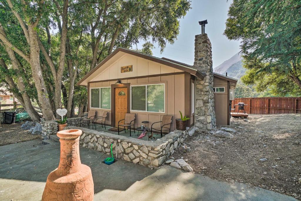 a small house with a stone wall at Cozy Cottage with Grill - 5 Mi to Mt Baldy Resort! in Mount Baldy