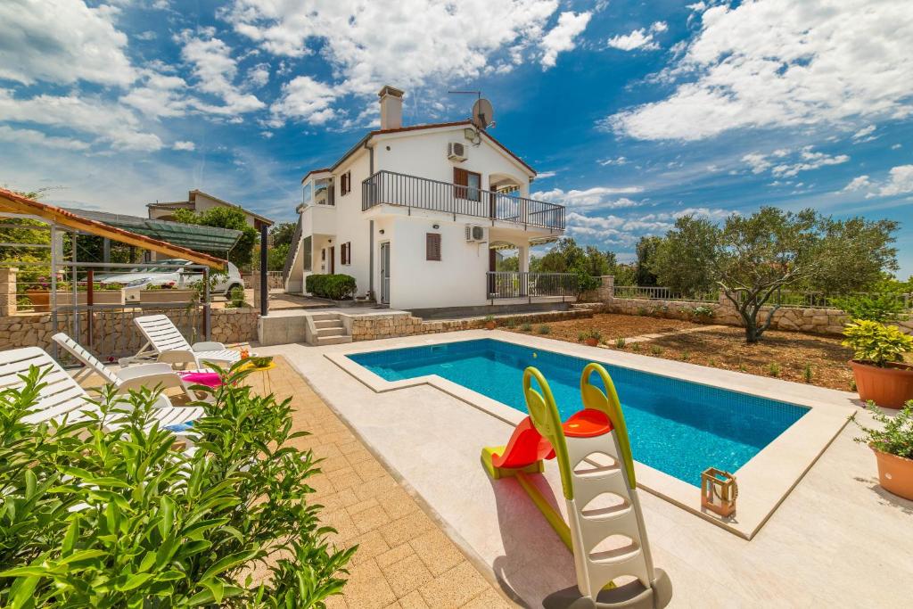 una casa con piscina y una casa en Holiday house Nena with pool, en Vinišće
