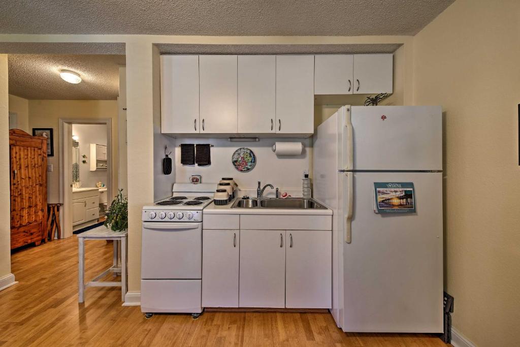 a kitchen with a white refrigerator and a sink at Nags Head Apt with Patio - half Mile Walk to Beach! in Nags Head