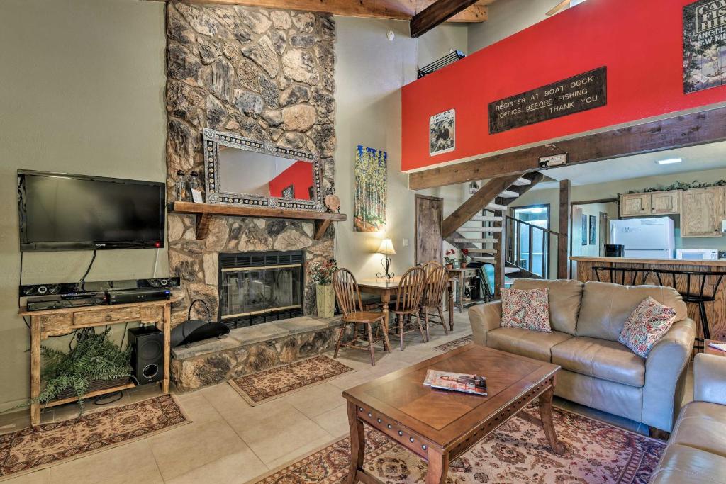ein Wohnzimmer mit einem Steinkamin und einem TV in der Unterkunft Condo with Grill Access Close to Angel Fire Resort in Angel Fire
