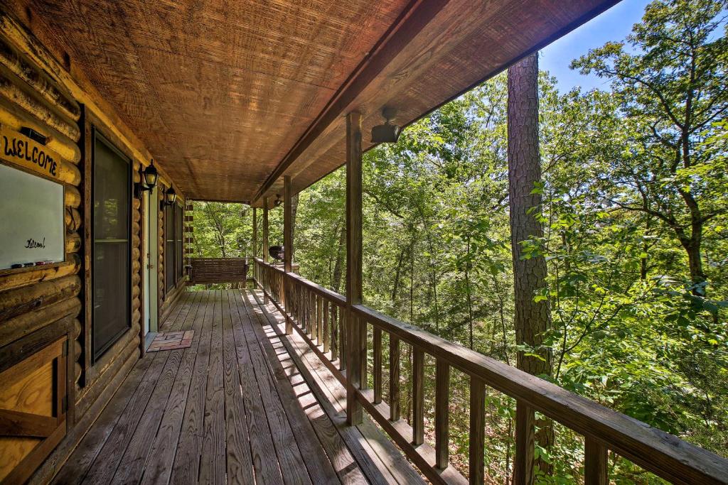 a wooden porch on a cabin in the woods at Eureka Springs Studio with Deck, Views and BBQ! in Eureka Springs