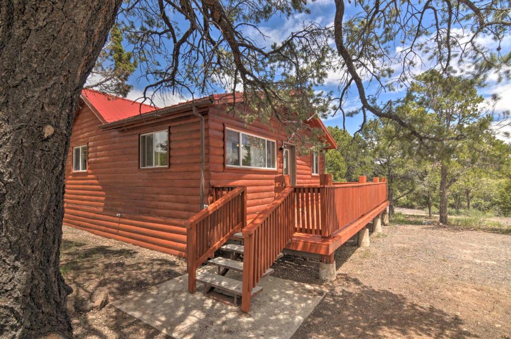 a cabin with a large deck next to a tree at Cabin 6 Mi to Burr Trail, 32 Mi to Escalante! in Boulder Town